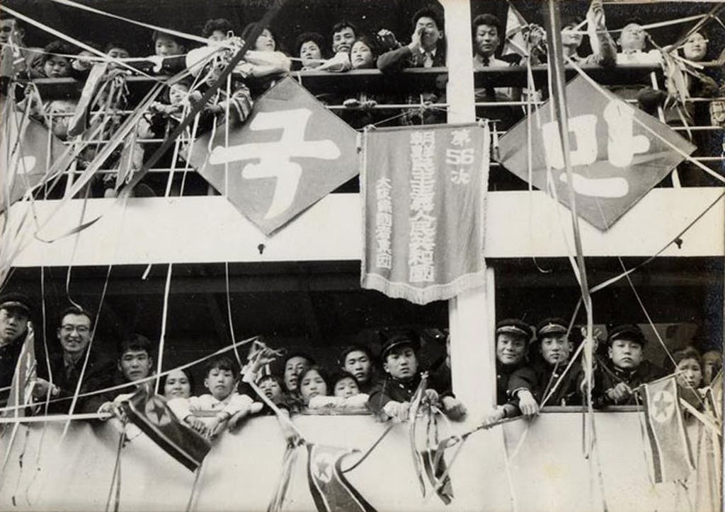 Koreans look down from the decks of the ship returning them to North Korea from Japan