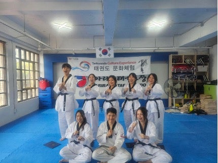 Students posing in a martial arts gym